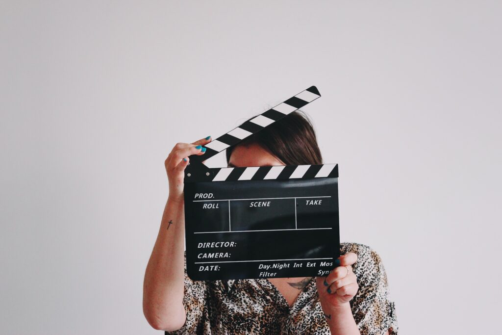A photo of a female actor holding a slate for a blog about how to start acting